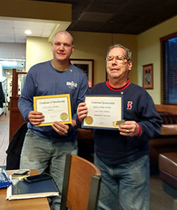 The photo at the center is of both new Lion Jim Beyer and President Marty holding their Certificates of Membership and Certificates of Sponsorship respectively.