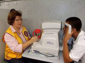 Image of an adult receiving a computerized eye screening